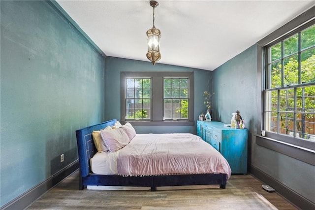 2334 Marengo St, New Orleans, LA 70115 - bedroom with vaulted ceiling, wood finished floors, and baseboards