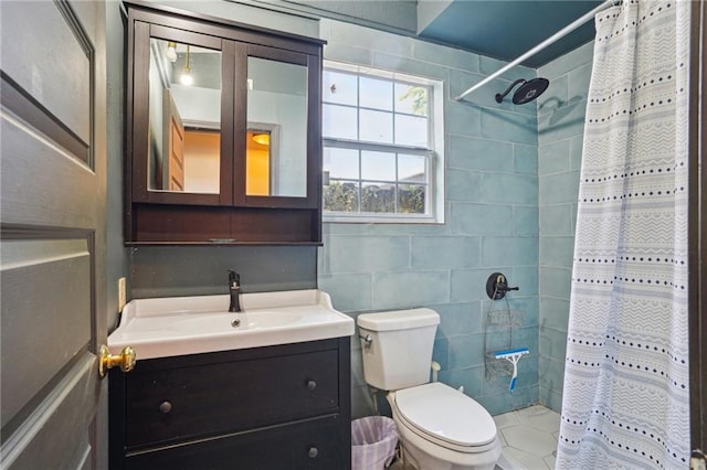 2334 Marengo St, New Orleans, LA 70115 - full bathroom featuring vanity, tiled shower, toilet, and tile walls