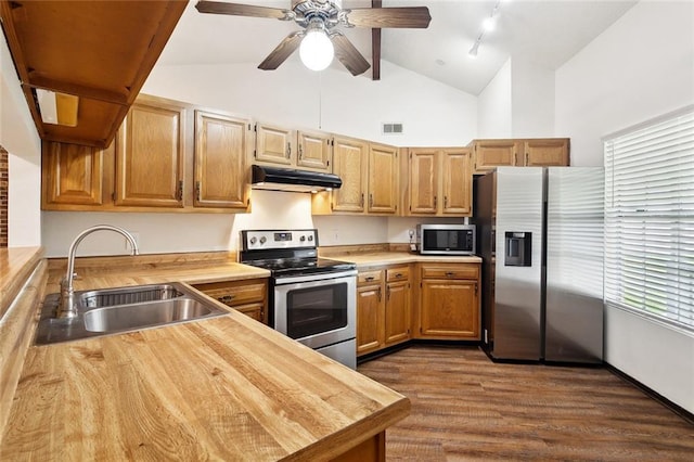 911 Forest Loop, Mandeville, LA 70471 - kitchen with stainless steel appliances, a sink, under cabinet range hood, dark wood-type flooring, and track lighting