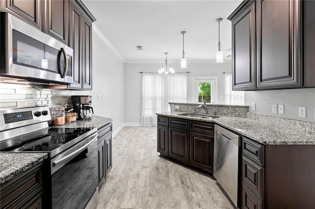 kitchen with stainless steel appliances, a chandelier, ornamental molding, dark brown cabinetry, and tasteful backsplash