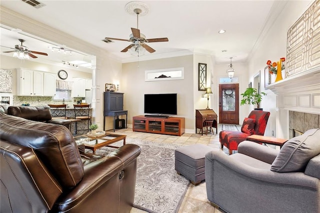 410 Doctor Gorman Dr, Belle Chasse, LA 70037 - living area with a ceiling fan, ornamental molding, light tile patterned floors, a fireplace, and baseboards