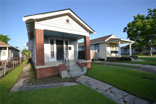 view of front facade with covered porch and brick siding