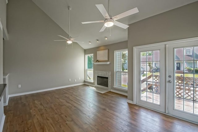 147 W Chamale Cv Unit 147, Slidell, LA 70460 - unfurnished living room with ceiling fan, dark wood finished floors, high vaulted ceiling, a fireplace with flush hearth, and baseboards