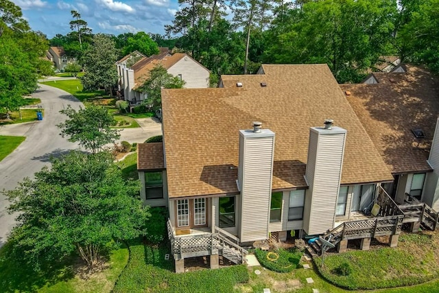 147 W Chamale Cv Unit 147, Slidell, LA 70460 - rear view of property featuring a shingled roof and a chimney