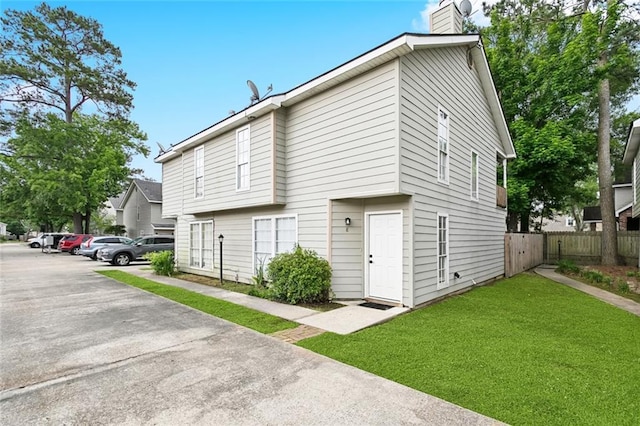 740 Heavens Dr Unit 8, Mandeville, LA 70471 - view of side of property with a chimney and uncovered parking