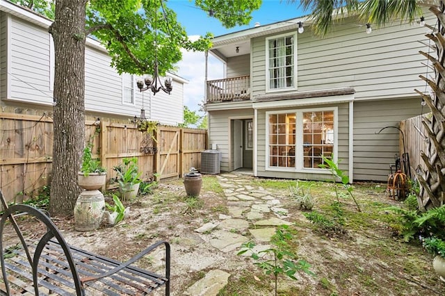 740 Heavens Dr Unit 8, Mandeville, LA 70471 - rear view of house featuring a balcony, a fenced backyard, and central air condition unit