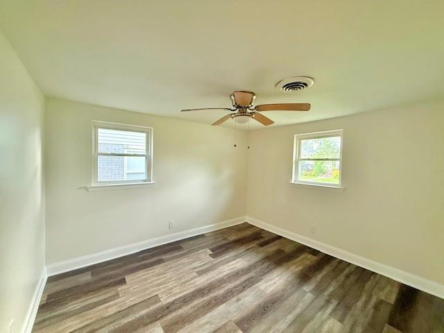 559 Resor Ave, Harahan, LA 70123 - unfurnished room featuring plenty of natural light, wood finished floors, baseboards, and a ceiling fan