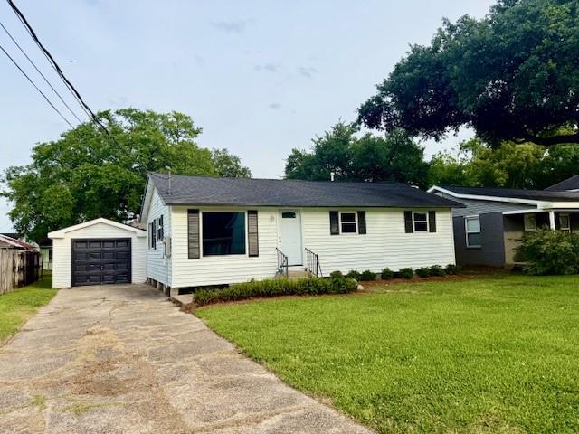 559 Resor Ave, Harahan, LA 70123 - view of front of property with concrete driveway, an outbuilding, a front lawn, and a detached garage