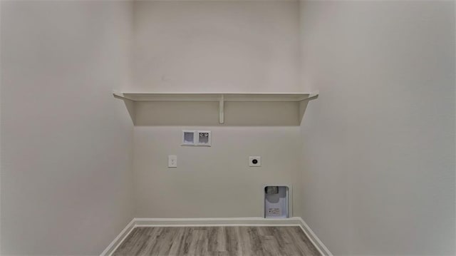 laundry area with electric dryer hookup, hookup for a washing machine, baseboards, and wood finished floors