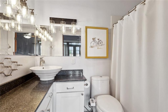 bathroom with a ceiling fan, vanity, and toilet