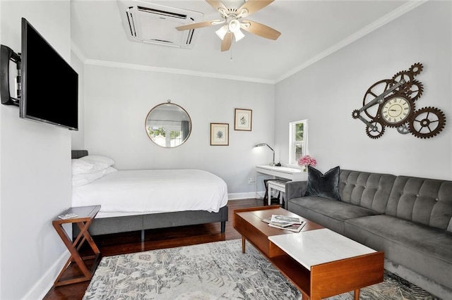 bedroom featuring baseboards, wood finished floors, ornamental molding, and ceiling fan