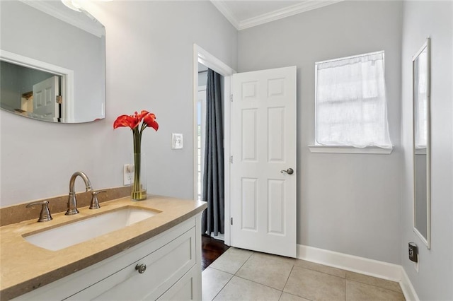 bathroom featuring tile patterned flooring, ornamental molding, vanity, and baseboards
