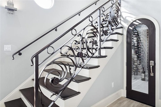 2283 Sunset Blvd, Slidell, LA 70461 - staircase featuring wood finished floors, baseboards, and arched walkways