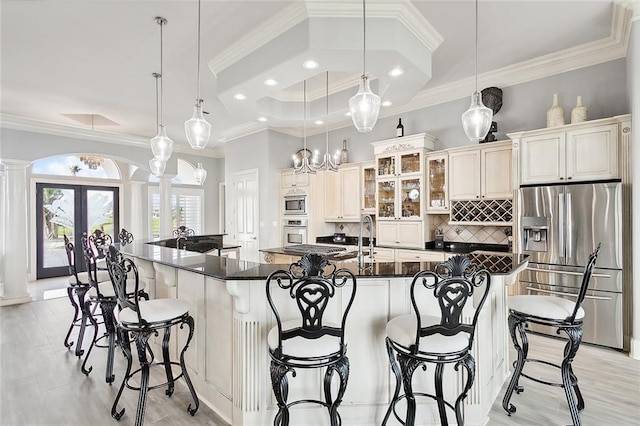 2283 Sunset Blvd, Slidell, LA 70461 - kitchen with appliances with stainless steel finishes, decorative columns, ornamental molding, decorative backsplash, and a breakfast bar