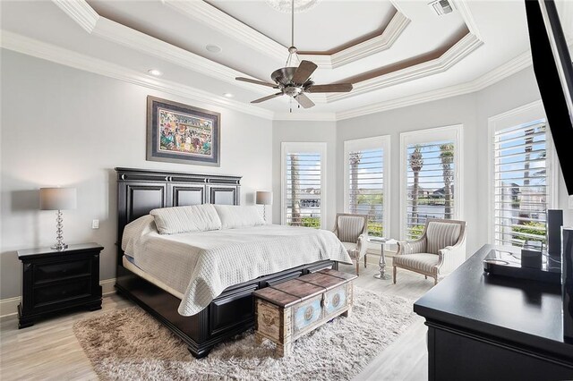 2283 Sunset Blvd, Slidell, LA 70461 - bedroom with multiple windows, a tray ceiling, crown molding, light wood-type flooring, and recessed lighting