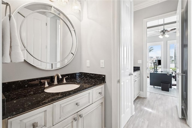 2283 Sunset Blvd, Slidell, LA 70461 - bathroom featuring ornamental molding, vanity, wood finished floors, ceiling fan, and baseboards