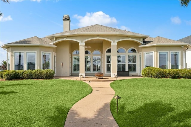 2283 Sunset Blvd, Slidell, LA 70461 - back of property featuring stucco siding, a lawn, a chimney, and a shingled roof