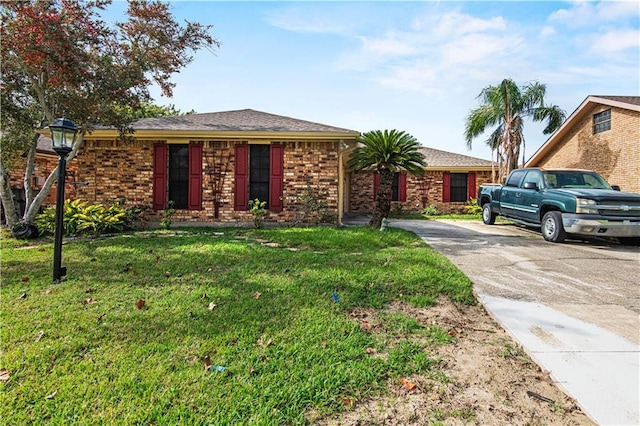 106 Eydie Ln, Slidell, LA 70458 - ranch-style house with driveway, a front yard, and brick siding