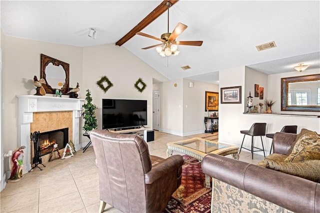 106 Eydie Ln, Slidell, LA 70458 - living room featuring light tile patterned floors, ceiling fan, a tiled fireplace, and baseboards
