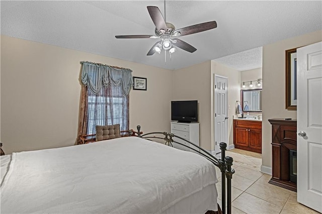 106 Eydie Ln, Slidell, LA 70458 - bedroom featuring light tile patterned floors, ensuite bathroom, ceiling fan, baseboards, and a textured ceiling