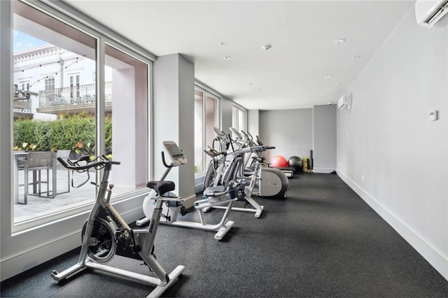 700 Magazine St Unit 513, New Orleans, LA 70130 - workout area featuring a wall mounted AC and baseboards