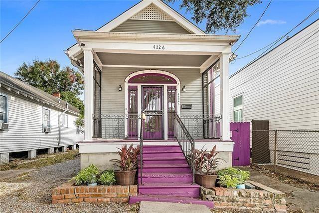 4226 S Carrollton Ave, New Orleans, LA 70119 - shotgun-style home with covered porch and fence