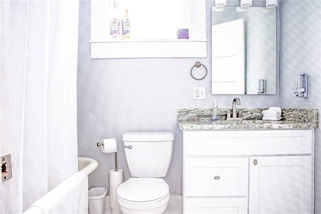 4226 S Carrollton Ave, New Orleans, LA 70119 - bathroom with toilet, vanity, and a bath