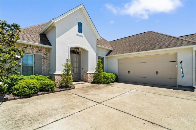 2021 Cypress Bend Dr, Madisonville, LA 70447 - view of front of house with roof with shingles, a garage, stucco siding, and driveway