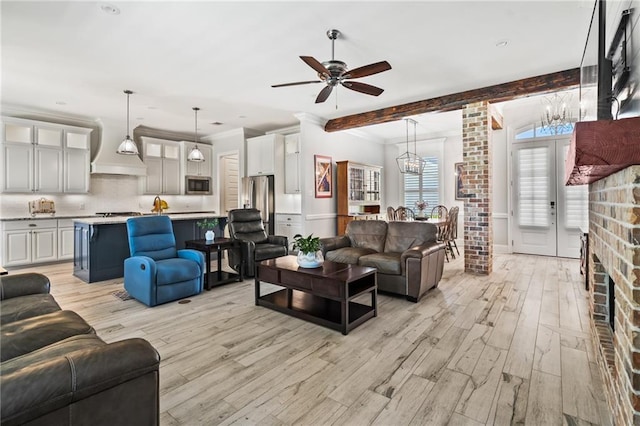 2021 Cypress Bend Dr, Madisonville, LA 70447 - living area with a chandelier, light wood-style flooring, ceiling fan, beamed ceiling, and ornamental molding