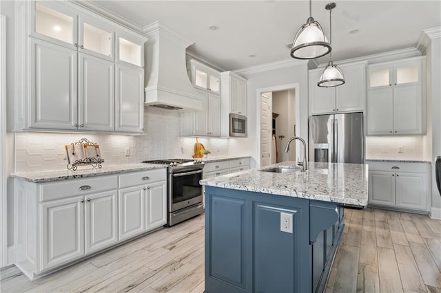 2021 Cypress Bend Dr, Madisonville, LA 70447 - kitchen featuring stainless steel appliances, premium range hood, a sink, light wood-style floors, and crown molding