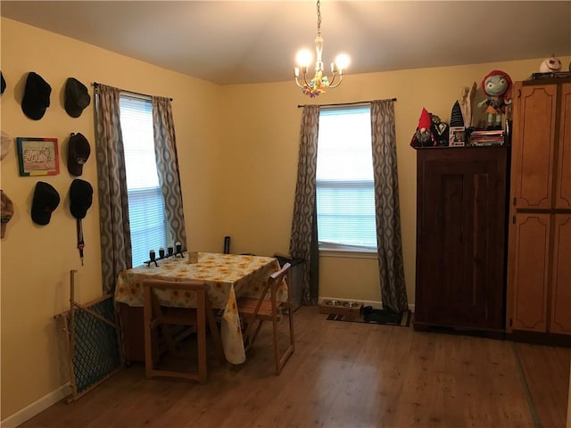 1105 Devonshire Dr, Slidell, LA 70461 - dining room with a chandelier, light wood finished floors, plenty of natural light, and baseboards