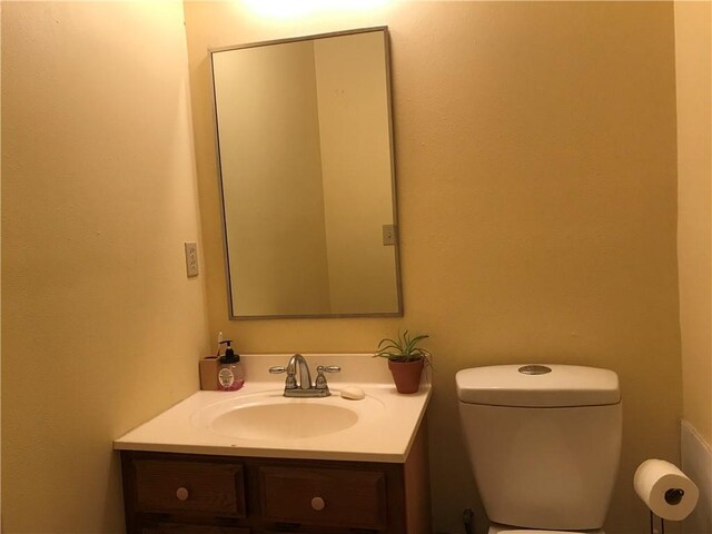 bathroom with toilet and vanity