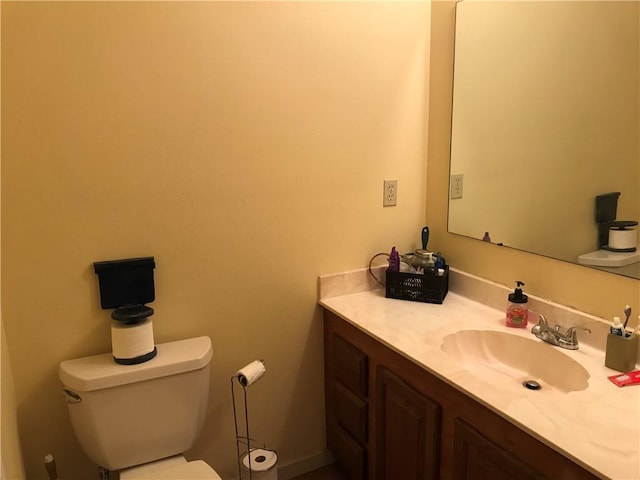 half bathroom featuring toilet and vanity
