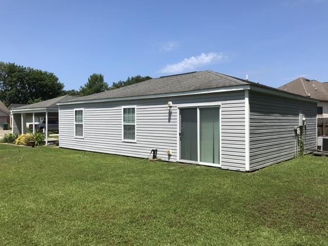 1105 Devonshire Dr, Slidell, LA 70461 - back of house featuring a lawn and central AC
