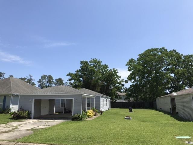 view of yard with driveway and an attached garage