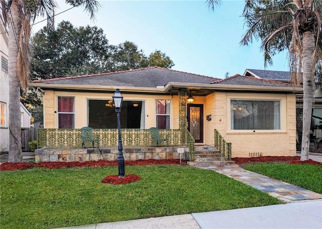 3630 Octavia St, New Orleans, LA 70125 - view of front of property featuring a front yard and brick siding