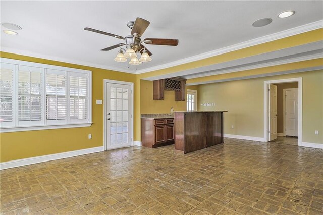 3630 Octavia St, New Orleans, LA 70125 - kitchen with baseboards, brick flooring, crown molding, ceiling fan, and light countertops