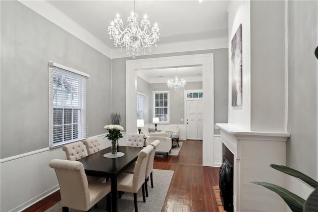 724 Port St, New Orleans, LA 70117 - dining room with a chandelier, dark wood-style flooring, plenty of natural light, and baseboards