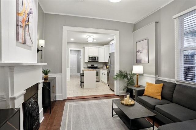 724 Port St, New Orleans, LA 70117 - living area featuring wood finished floors, crown molding, and baseboards