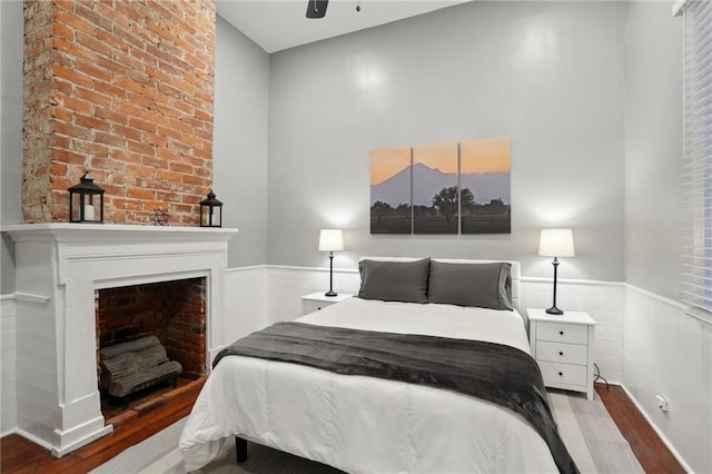 724 Port St, New Orleans, LA 70117 - bedroom with wood finished floors, wainscoting, and ceiling fan