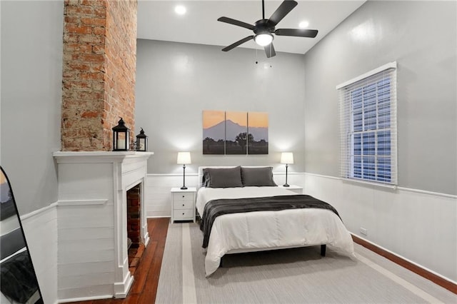 724 Port St, New Orleans, LA 70117 - bedroom with wood finished floors, a fireplace, and ceiling fan