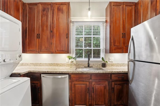 724 Port St, New Orleans, LA 70117 - kitchen featuring stainless steel appliances, a sink, light stone counters, and hanging light fixtures