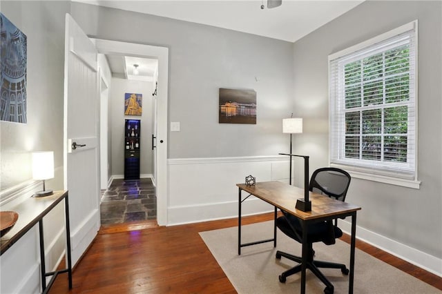 724 Port St, New Orleans, LA 70117 - office area featuring dark wood-type flooring and baseboards
