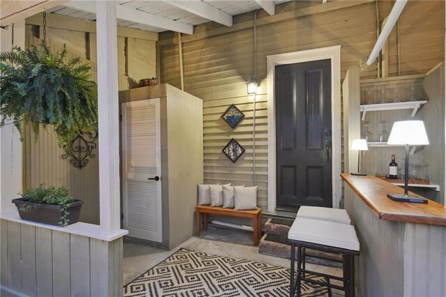 724 Port St, New Orleans, LA 70117 - dining space featuring wood walls, a chandelier, beamed ceiling, and wooden ceiling