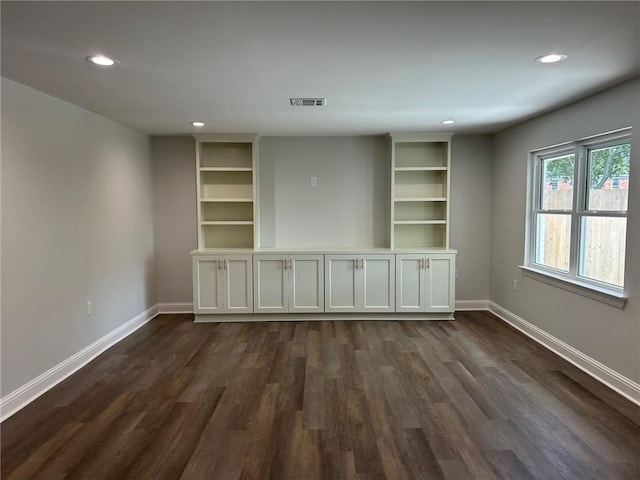 spare room with recessed lighting, dark wood-type flooring, and baseboards