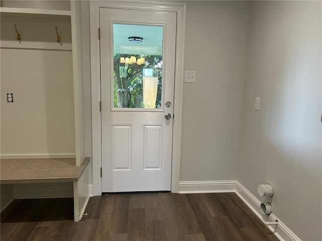 doorway to outside with dark wood-style floors and baseboards