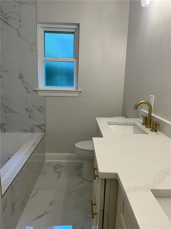 full bath with marble look tile flooring, baseboards, vanity, and toilet