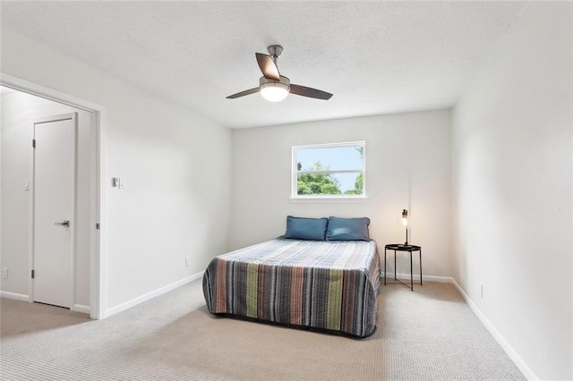 bedroom with light carpet and baseboards
