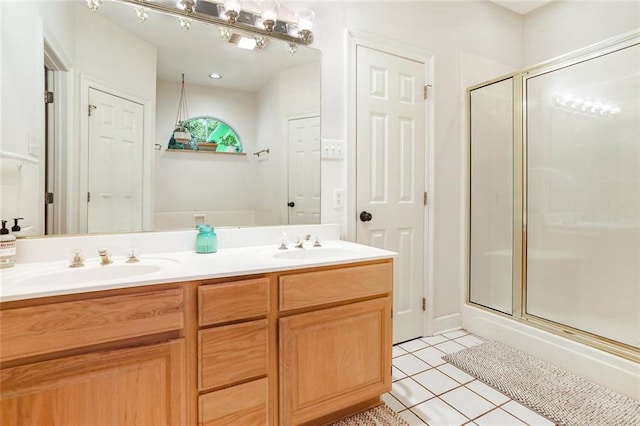 bathroom featuring tile patterned floors, a stall shower, and double vanity