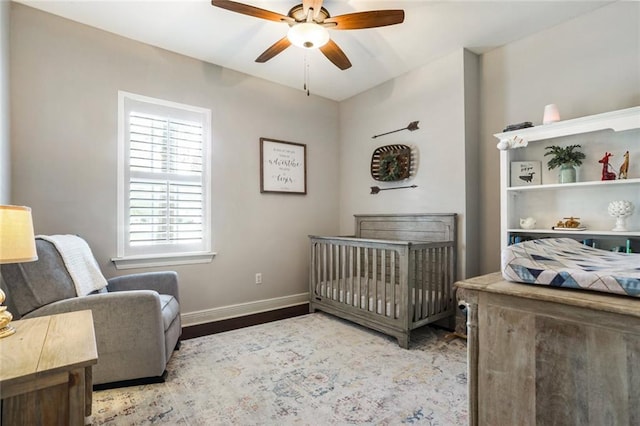 bedroom with baseboards, wood finished floors, and ceiling fan
